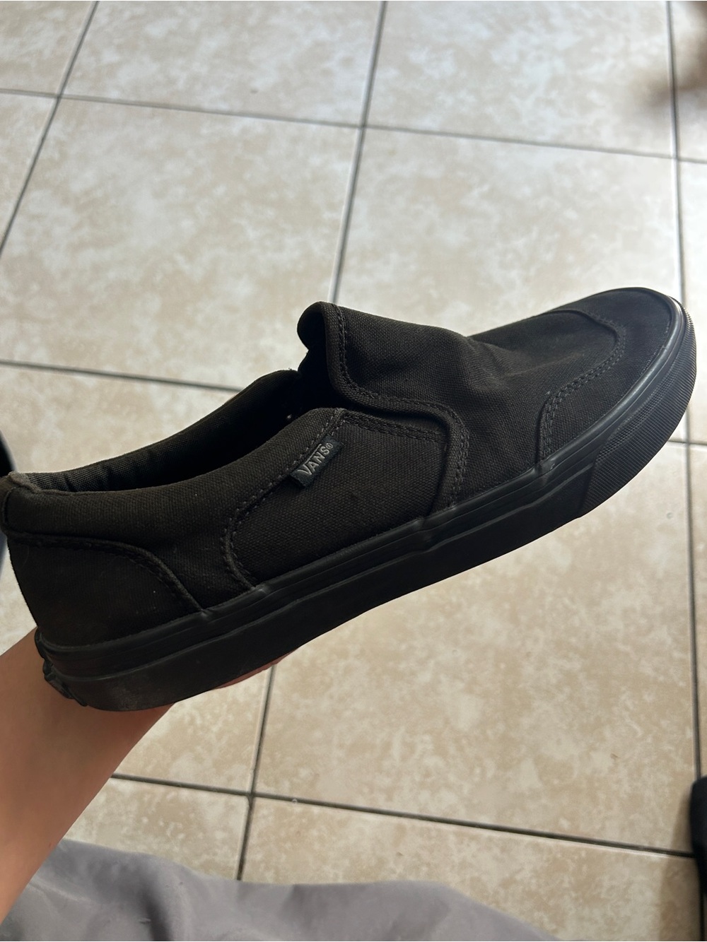 Black Vans slip-on sneakers
